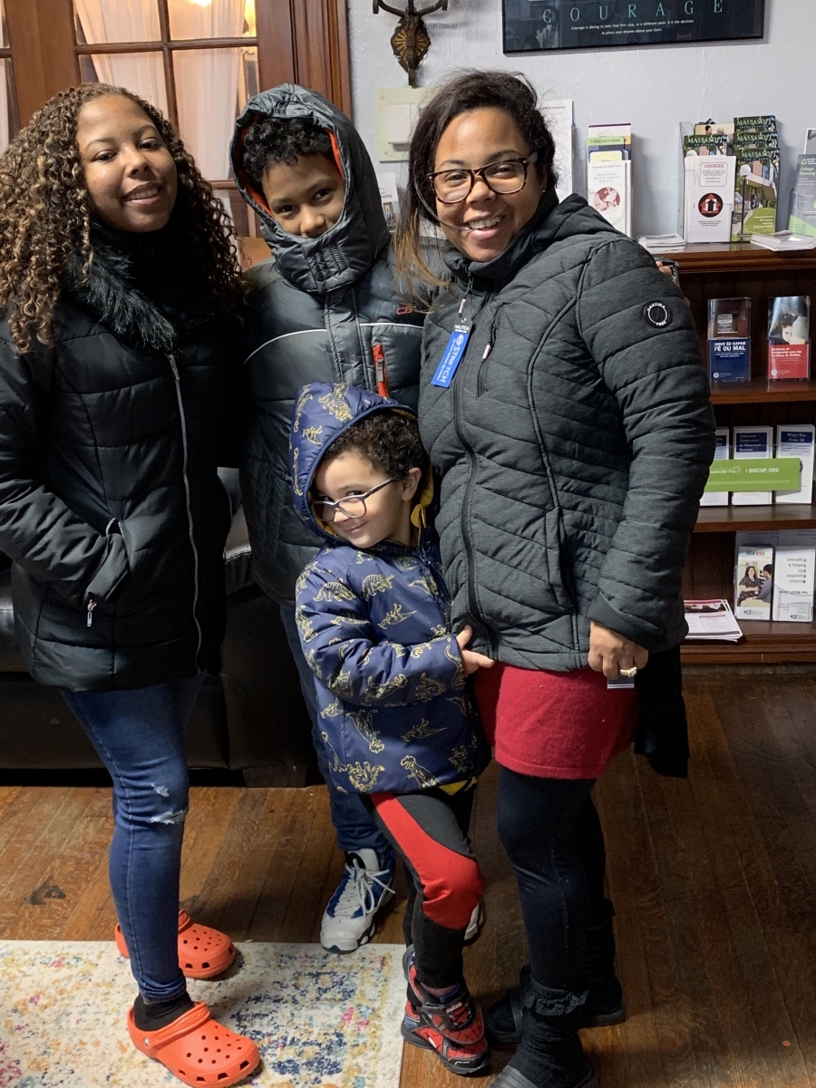 Kids model their new coats at United Way’s Family Center