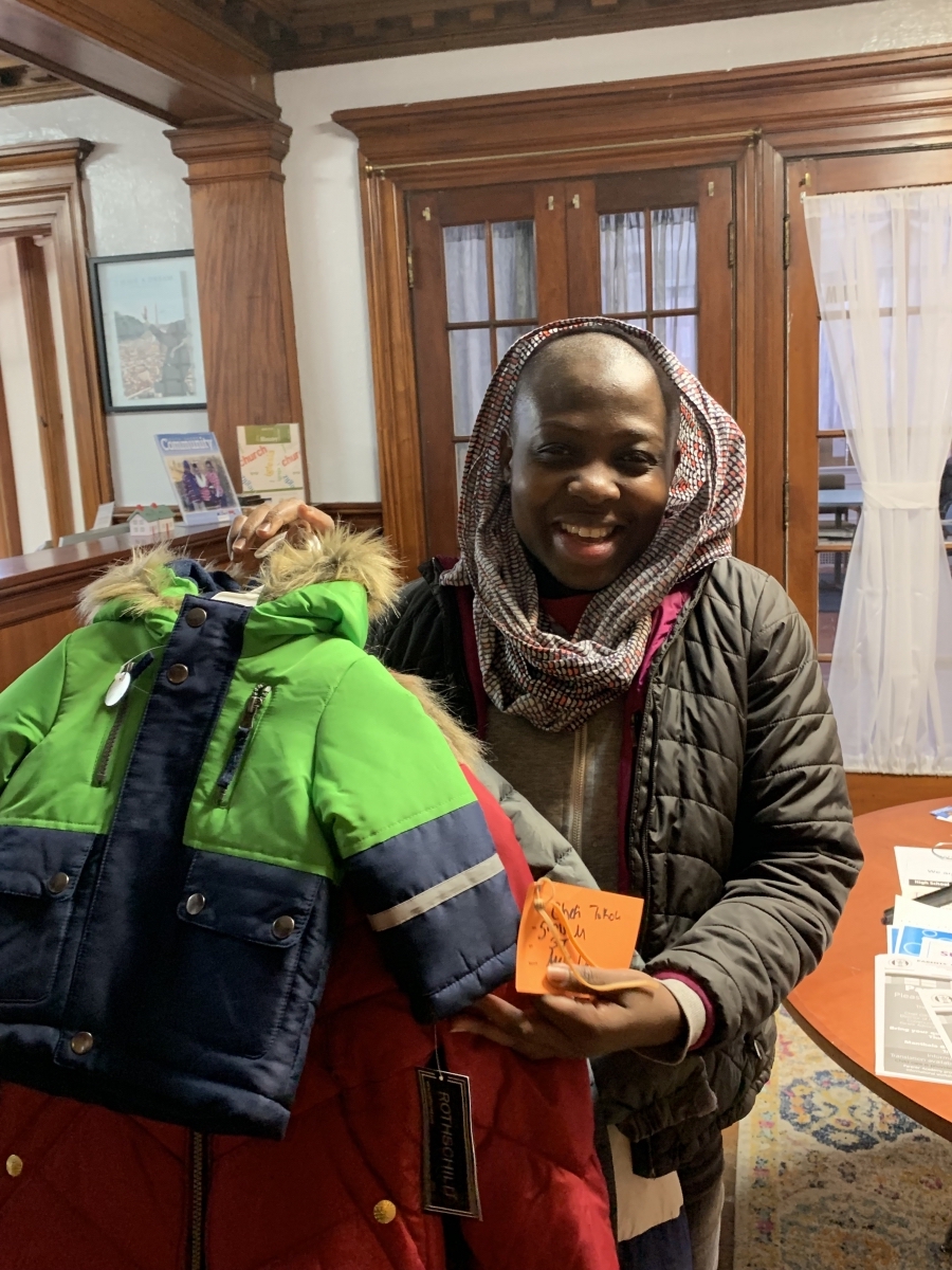 A mom picks up coats for her children at United Way’s Family Center